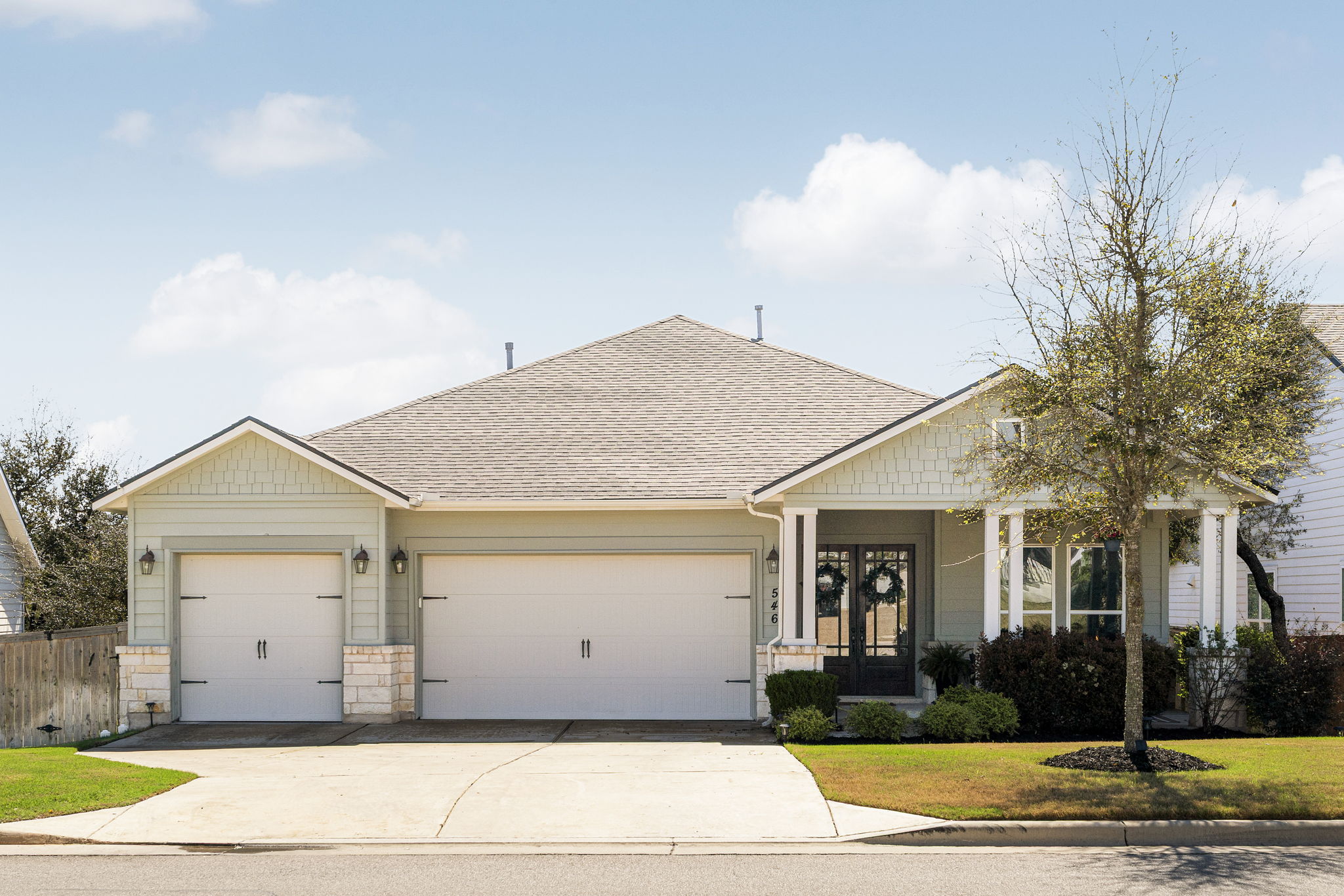 546 Hazy Hills Loop Dripping Springs, TX 78620 - Photo 35 of 40 The home’s charming exterior and spacious driveway complement the coveted three-car side-by-side garage.