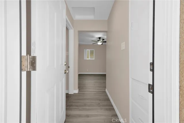 a view of a hallway with wooden floor