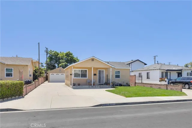 a front view of a house with a garden and plants