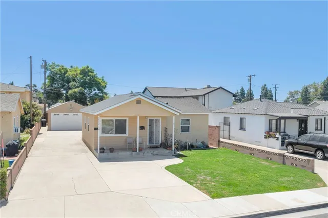 a front view of a house with a garden and patio