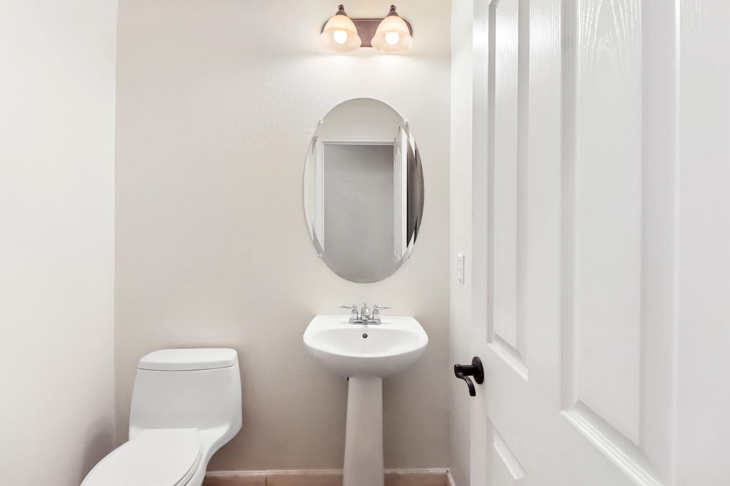 2012 Muscovy Road West Sacramento, CA 95691 - Photo 32 of 42 a bathroom with a toilet sink and mirror