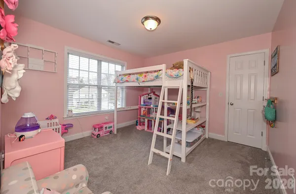 a bedroom with furniture and a window