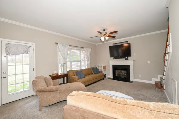 a living room with furniture a fireplace and a flat screen tv