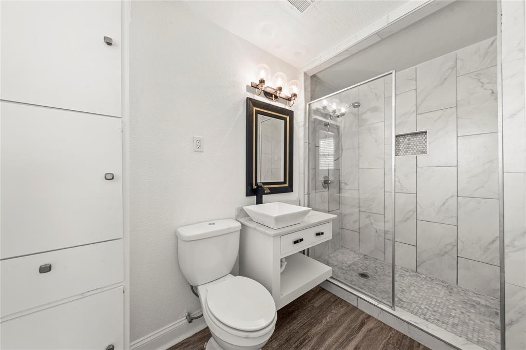 104 East Santa Anna Street Robinson, TX 76706 - Photo 27 of 36 a bathroom with a toilet a sink and shower