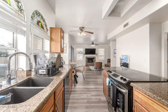a kitchen with stainless steel appliances granite countertop a sink stove and refrigerator