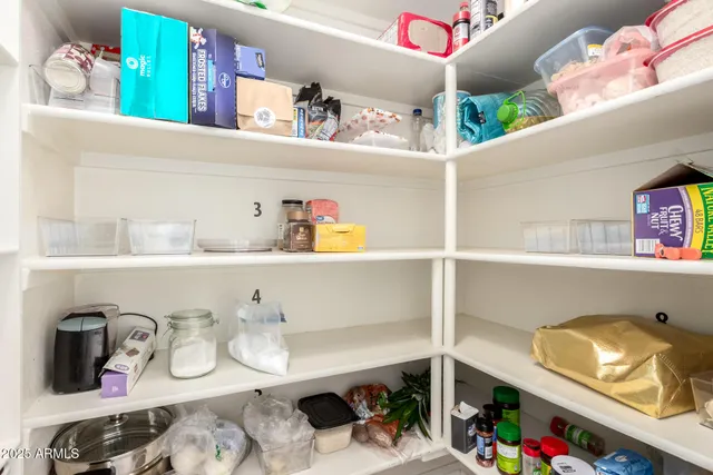 a kitchen with lots of clutter and cabinets