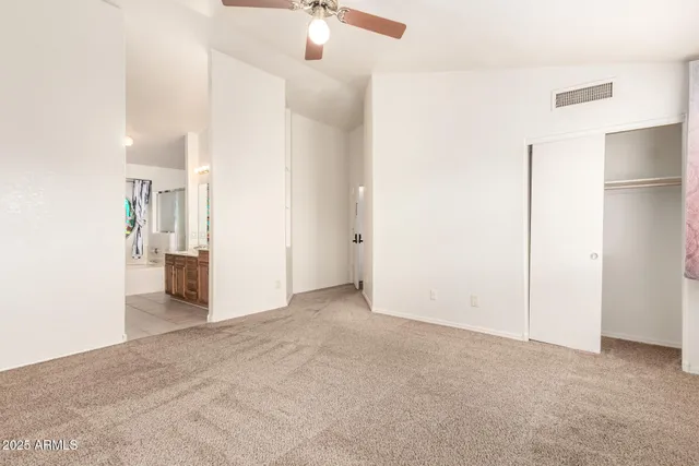 an empty room with fan and entrance