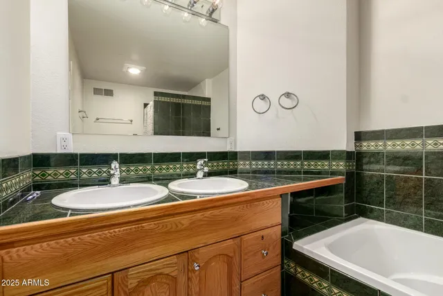 a bathroom with a sink a mirror and a bathtub