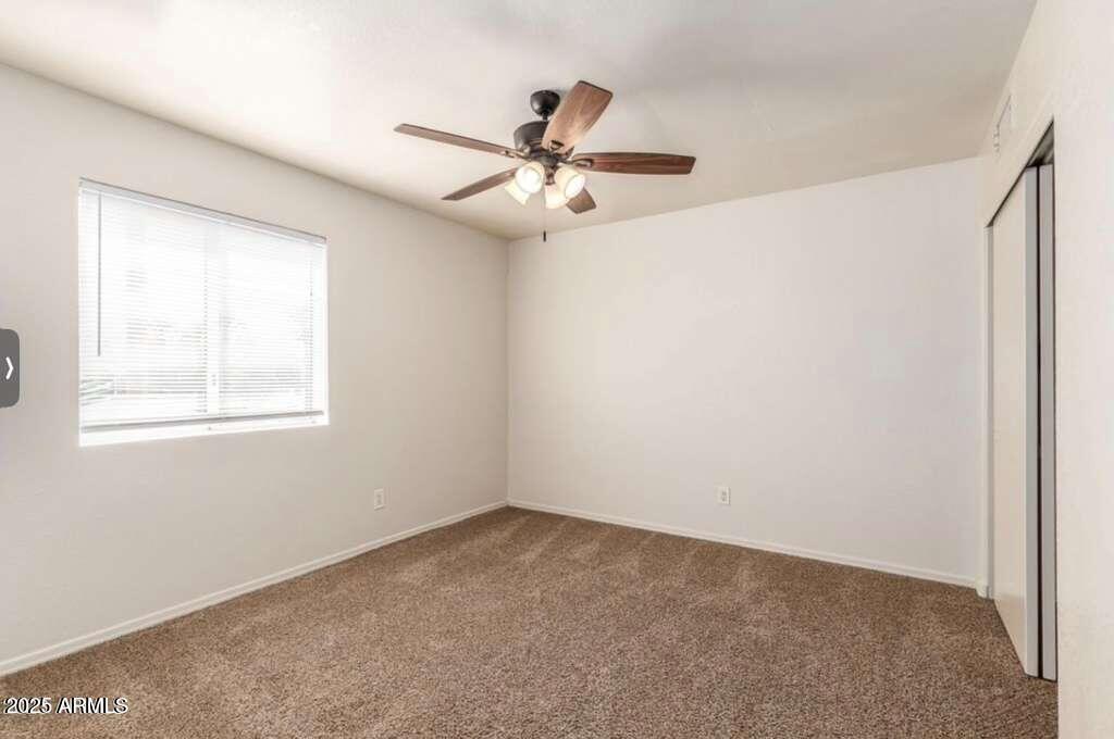 1691 East Gary Drive Chandler, AZ 85225 - Photo 27 of 45 an empty room with windows and fan