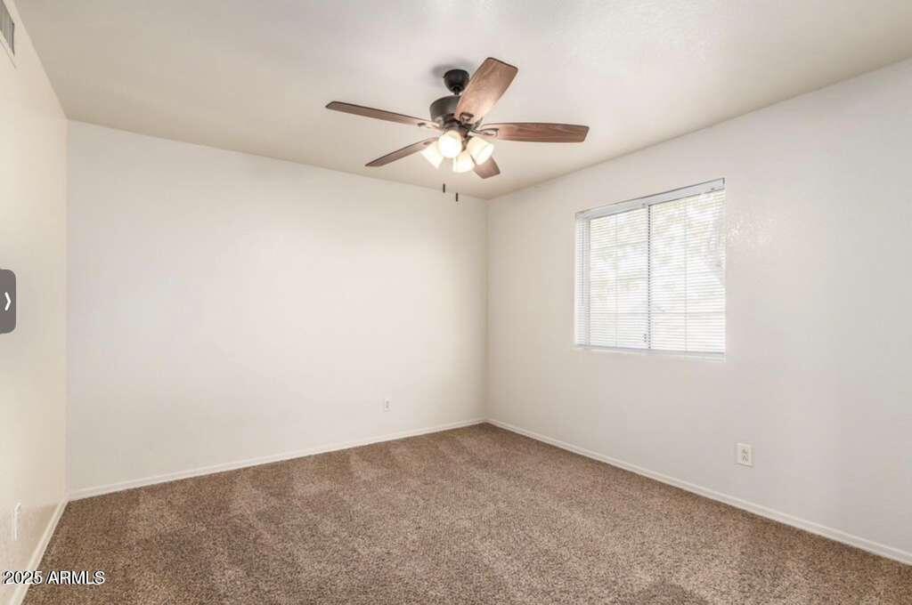 1691 East Gary Drive Chandler, AZ 85225 - Photo 29 of 45 an empty room with a window and a fan