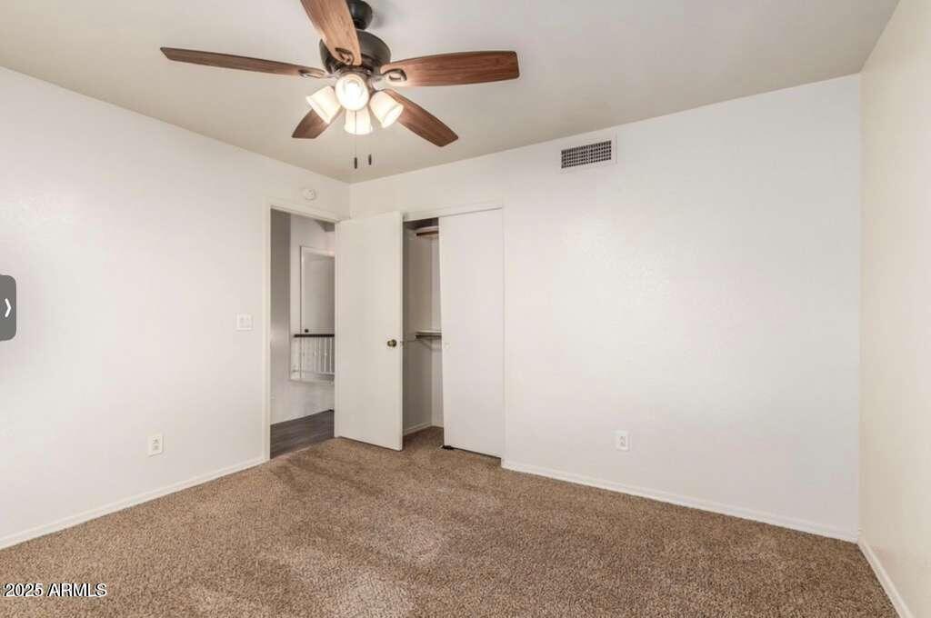 1691 East Gary Drive Chandler, AZ 85225 - Photo 30 of 45 an empty room with a chandelier fan and a ceiling fan