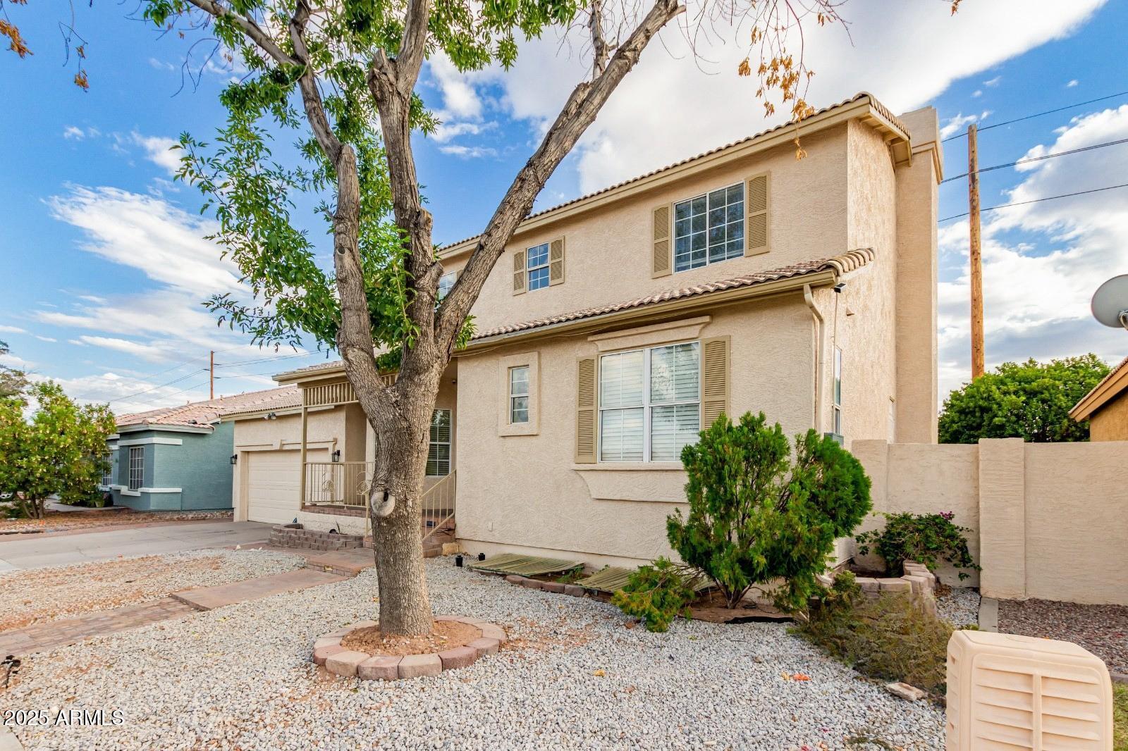 1691 East Gary Drive Chandler, AZ 85225 - Photo 3 of 45 a front view of a house with garden