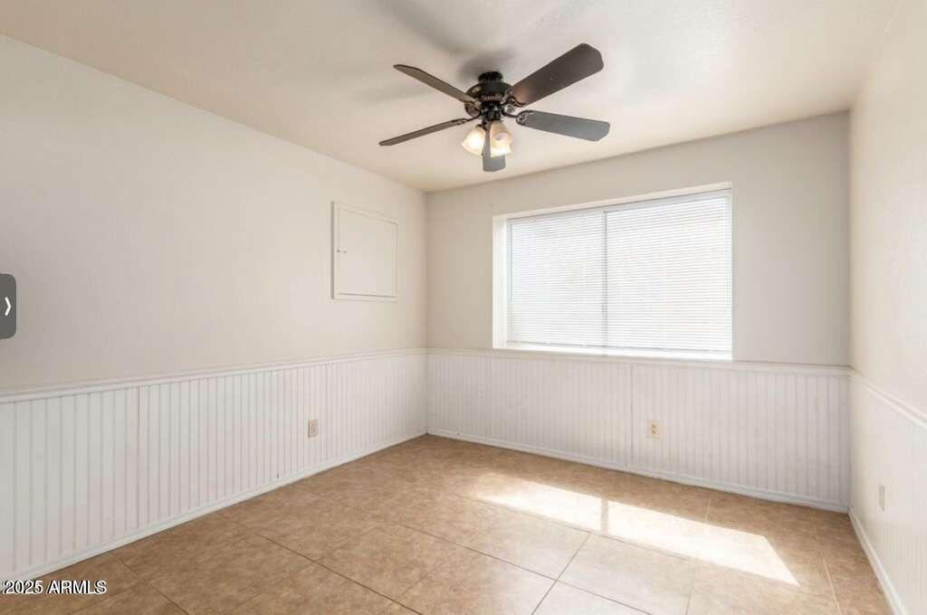 1691 East Gary Drive Chandler, AZ 85225 - Photo 34 of 45 an empty room with a window and a fan