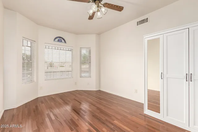 a view of a livingroom with a ceiling fan and window