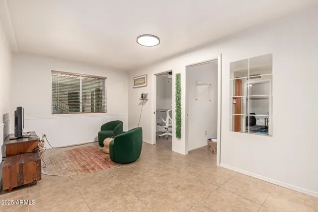 a living room with furniture windows and a flat screen tv
