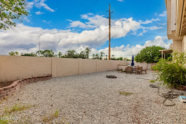 a view of a house with backyard and sitting area