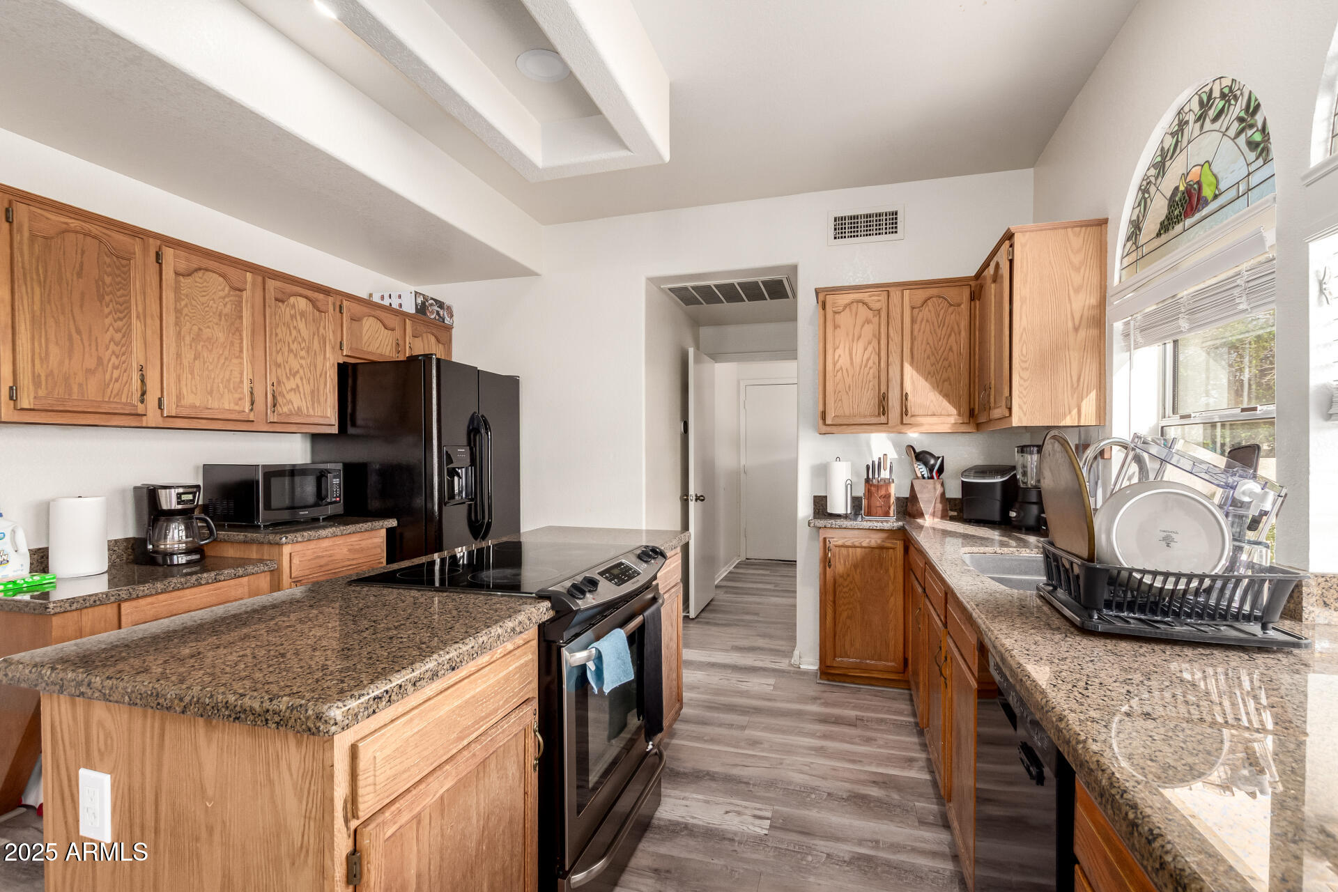 1691 East Gary Drive Chandler, AZ 85225 - Photo 10 of 45 a kitchen with granite countertop a sink stove and refrigerator