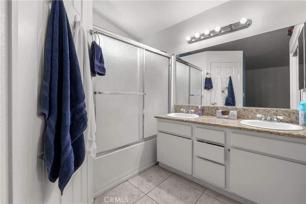 15417 Tobarra Road Fontana, CA 92337 - Photo 24 of 29 a bathroom with a double vanity sink and a mirror