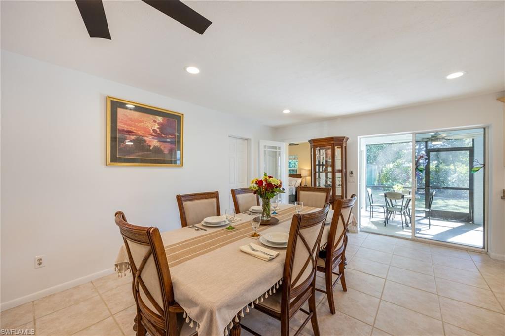 736 92nd Avenue North Naples, FL 34108 - Photo 12 of 25 a dining room with furniture and a floor to ceiling window