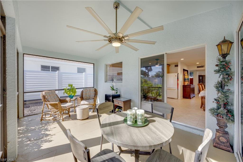 736 92nd Avenue North Naples, FL 34108 - Photo 14 of 25 a dining room with furniture a rug and a chandelier
