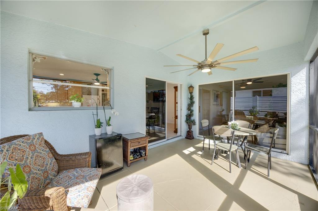 736 92nd Avenue North Naples, FL 34108 - Photo 15 of 25 a living room with furniture a large window and a table