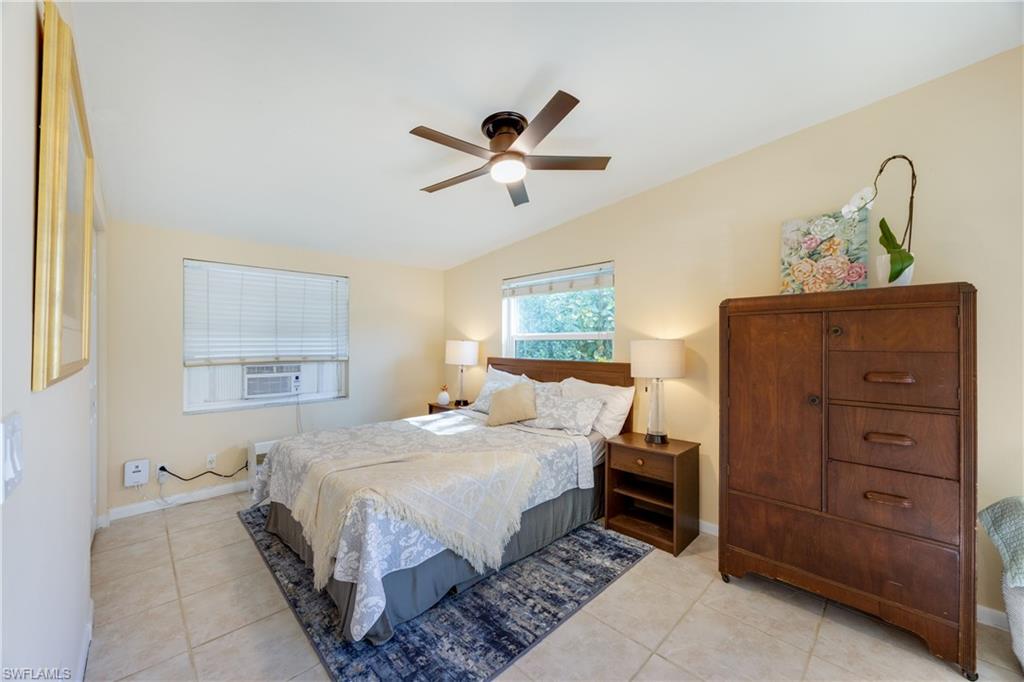 736 92nd Avenue North Naples, FL 34108 - Photo 17 of 25 a bedroom with a bed and a dresser