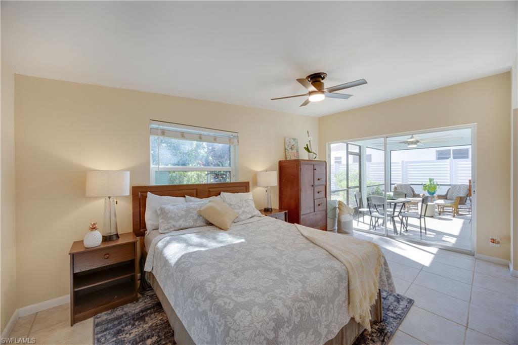 736 92nd Avenue North Naples, FL 34108 - Photo 18 of 25 a bedroom with a large bed and a chandelier