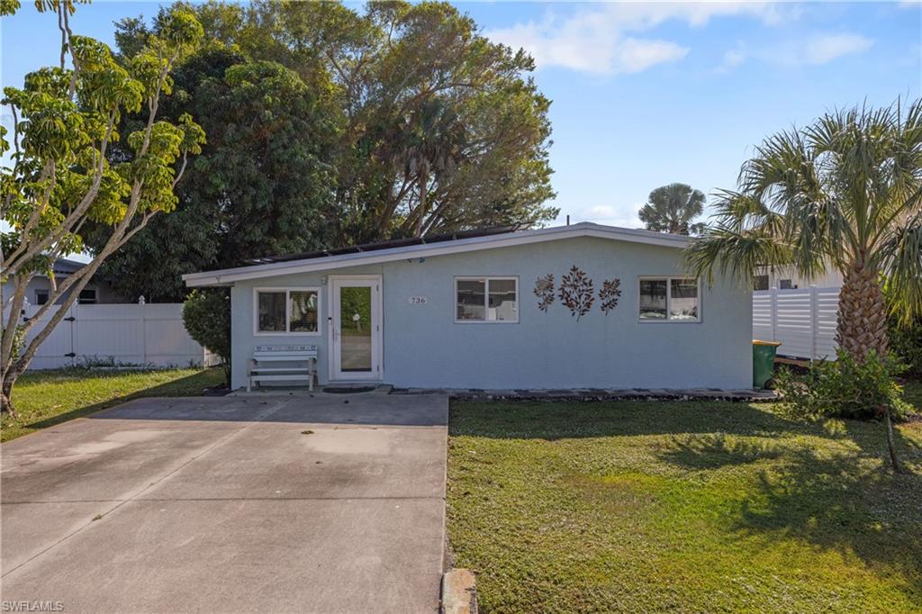 736 92nd Avenue North Naples, FL 34108 - Photo 2 of 25 a view of a house with pool and a yard