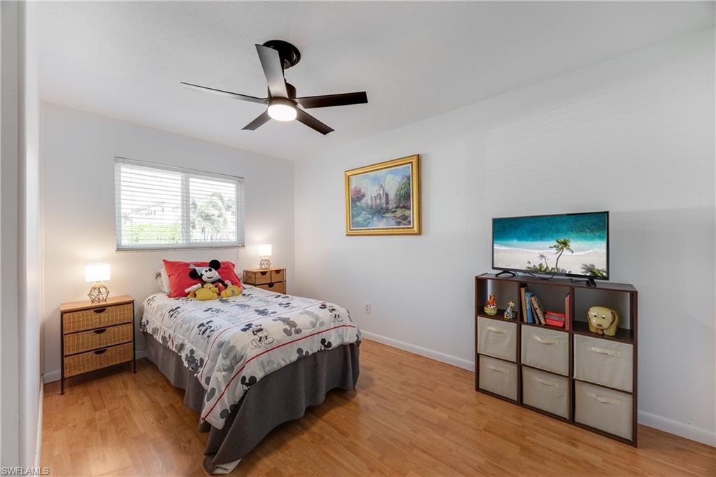 736 92nd Avenue North Naples, FL 34108 - Photo 22 of 25 a bedroom with a bed and a dresser in it