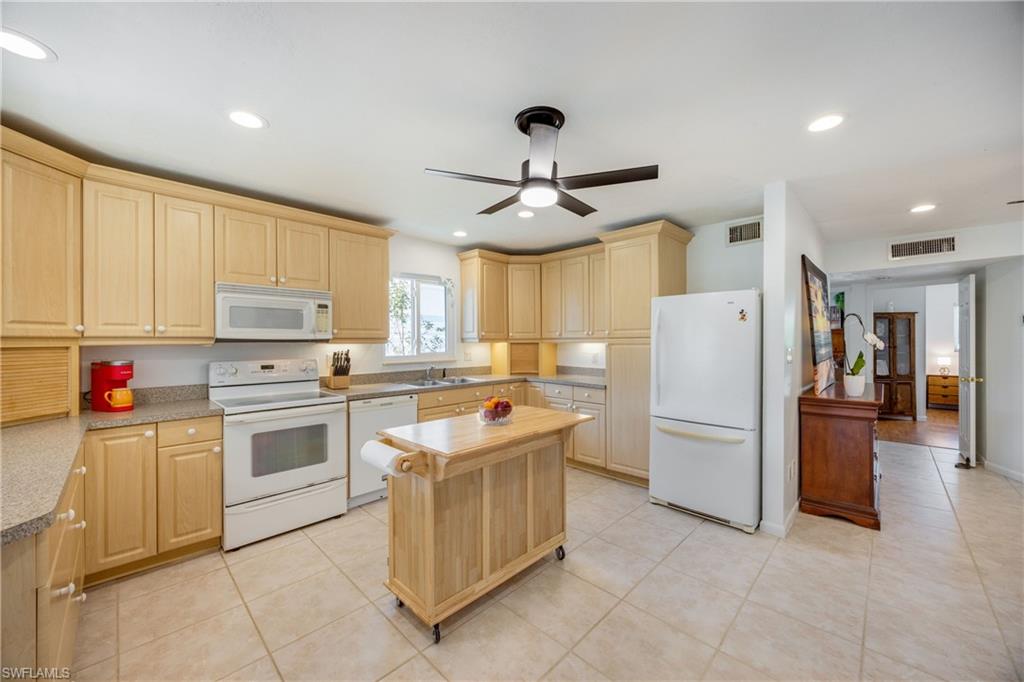 736 92nd Avenue North Naples, FL 34108 - Photo 10 of 25 a kitchen with a refrigerator and a sink