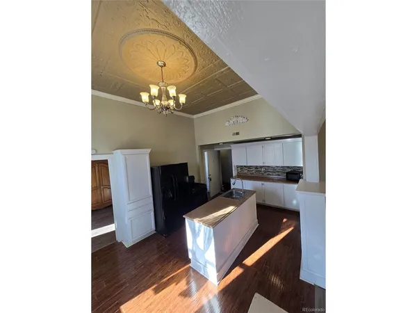 a living room with furniture and a chandelier