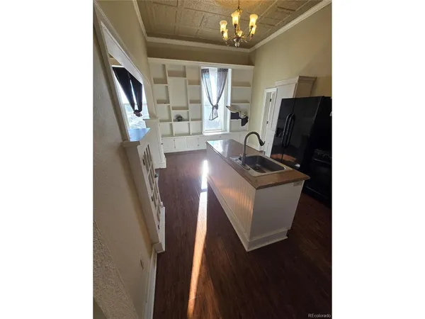 a view of a workspace with furniture and a chandelier