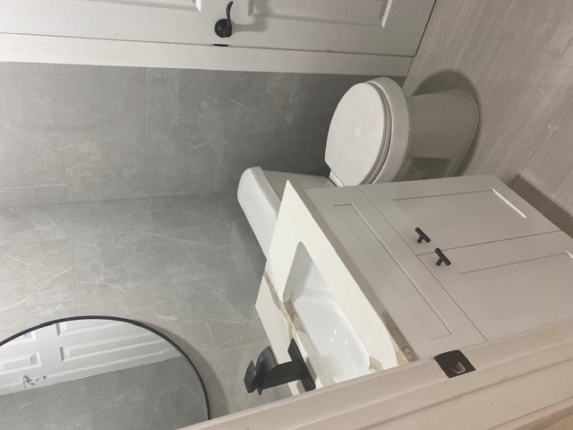 183 Mimosa Road Dale, TX 78616 - Photo 6 of 11 Bathroom featuring a white vanity with a rectangular sink, a light-toned countertop, and matte black fixtures