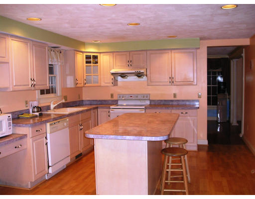 10 Chapelgate Road Canton, MA 02021 - Photo 2 of 11 a kitchen with stainless steel appliances granite countertop a sink and cabinets