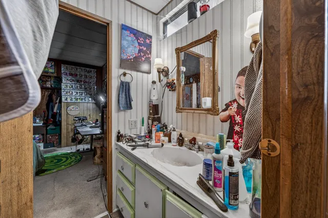 a bathroom with a sink vanity and mirror