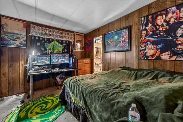 a bed sitting in a bedroom next to a window