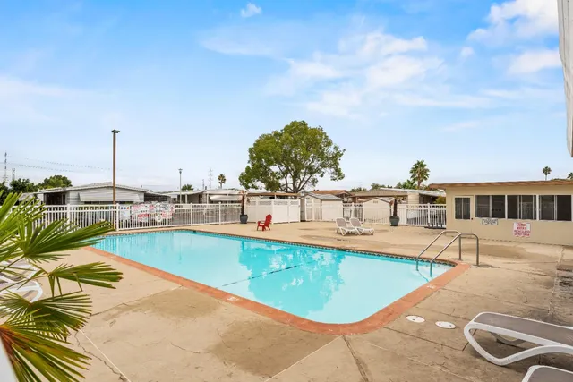 a view of a swimming pool with outdoor seating