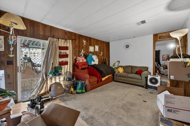 a living room with furniture a flat screen tv and a window