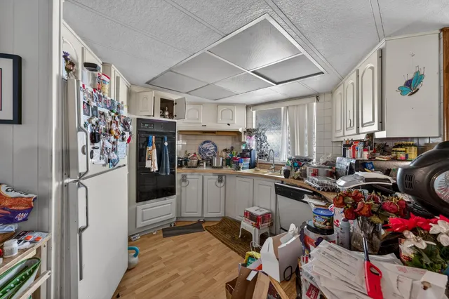 a kitchen that has a lot of cabinets and refrigerator