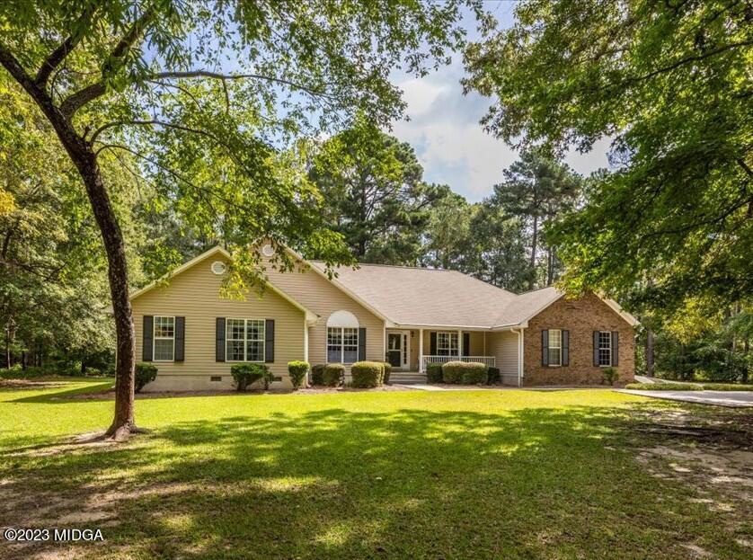 a front view of a house with swimming pool having outdoor seating