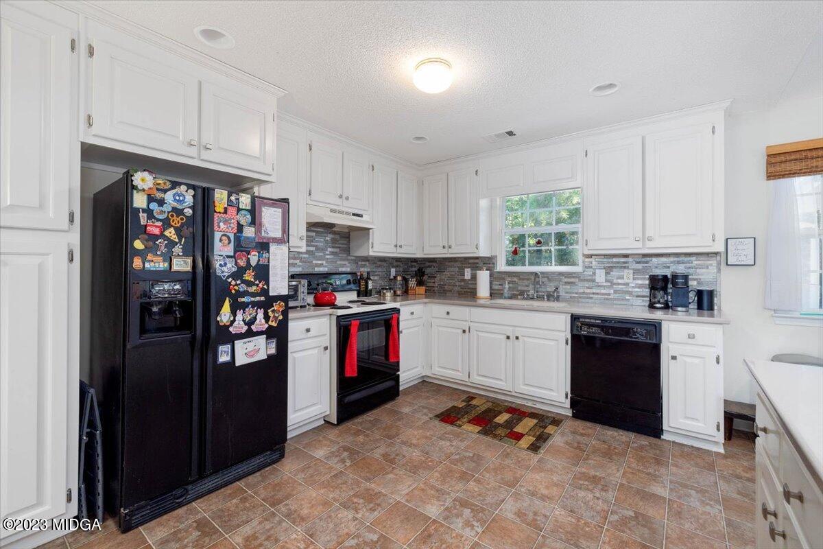 239 Altman Road Gray, GA 31032 - Photo 12 of 46 a kitchen with stainless steel appliances granite countertop a refrigerator sink and stove