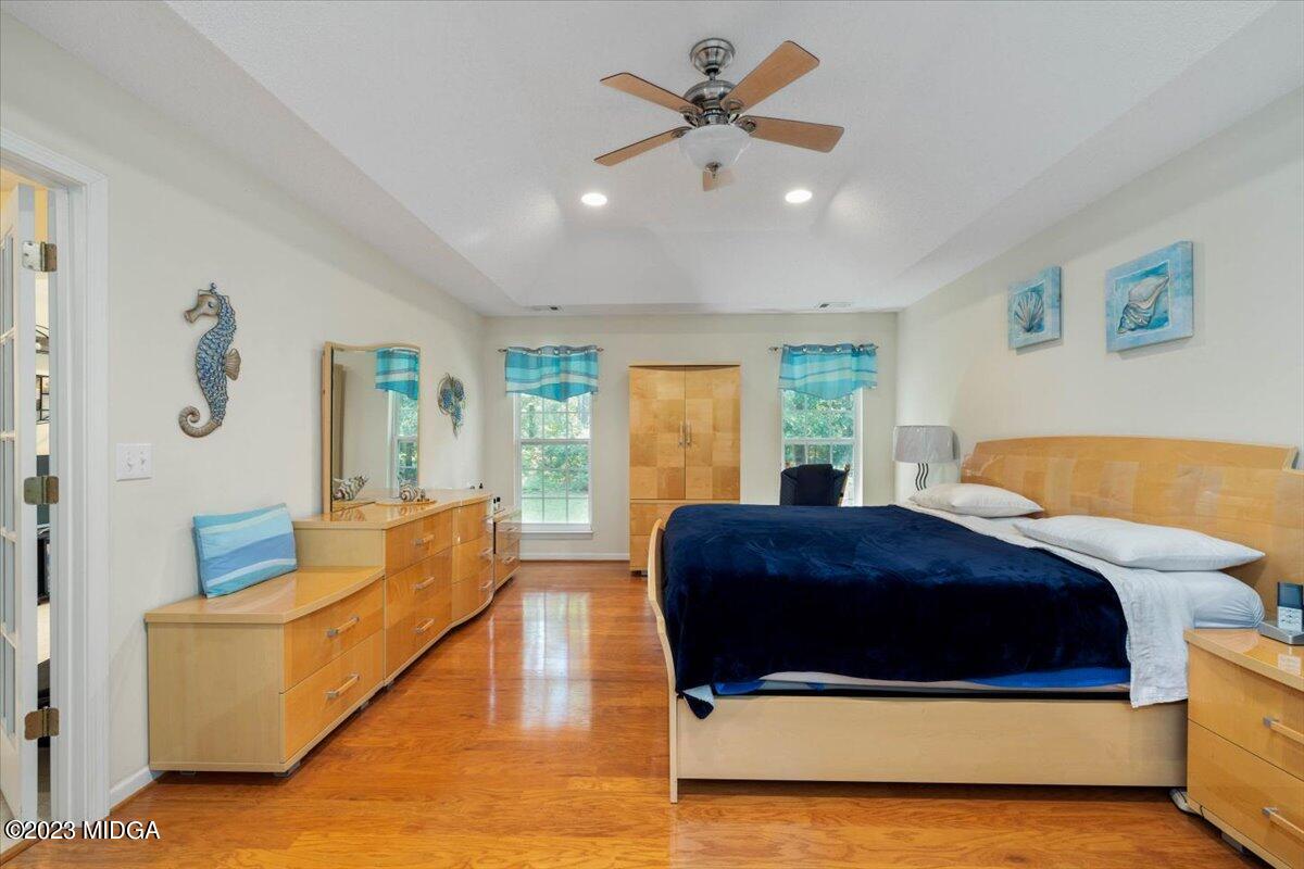 239 Altman Road Gray, GA 31032 - Photo 18 of 46 a spacious bedroom with a bed a couch and a window