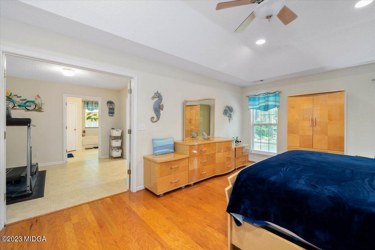 239 Altman Road Gray, GA 31032 - Photo 19 of 46 a bedroom with a large bed and ceiling fan
