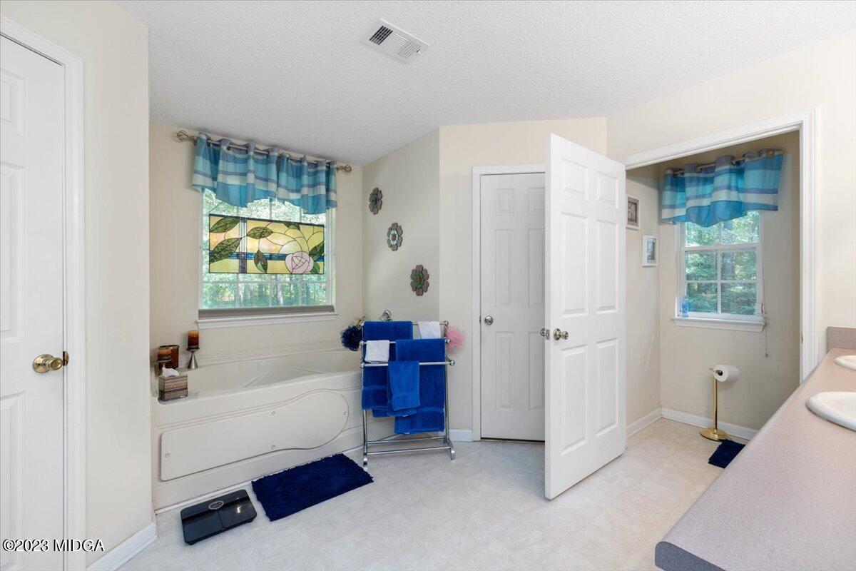 239 Altman Road Gray, GA 31032 - Photo 20 of 46 a bathroom with a bathtub and a shower