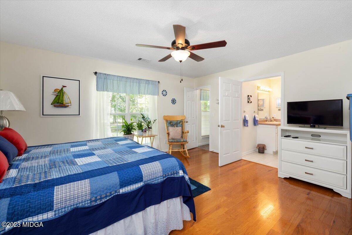 239 Altman Road Gray, GA 31032 - Photo 24 of 46 a bedroom with a bed and a flat screen tv