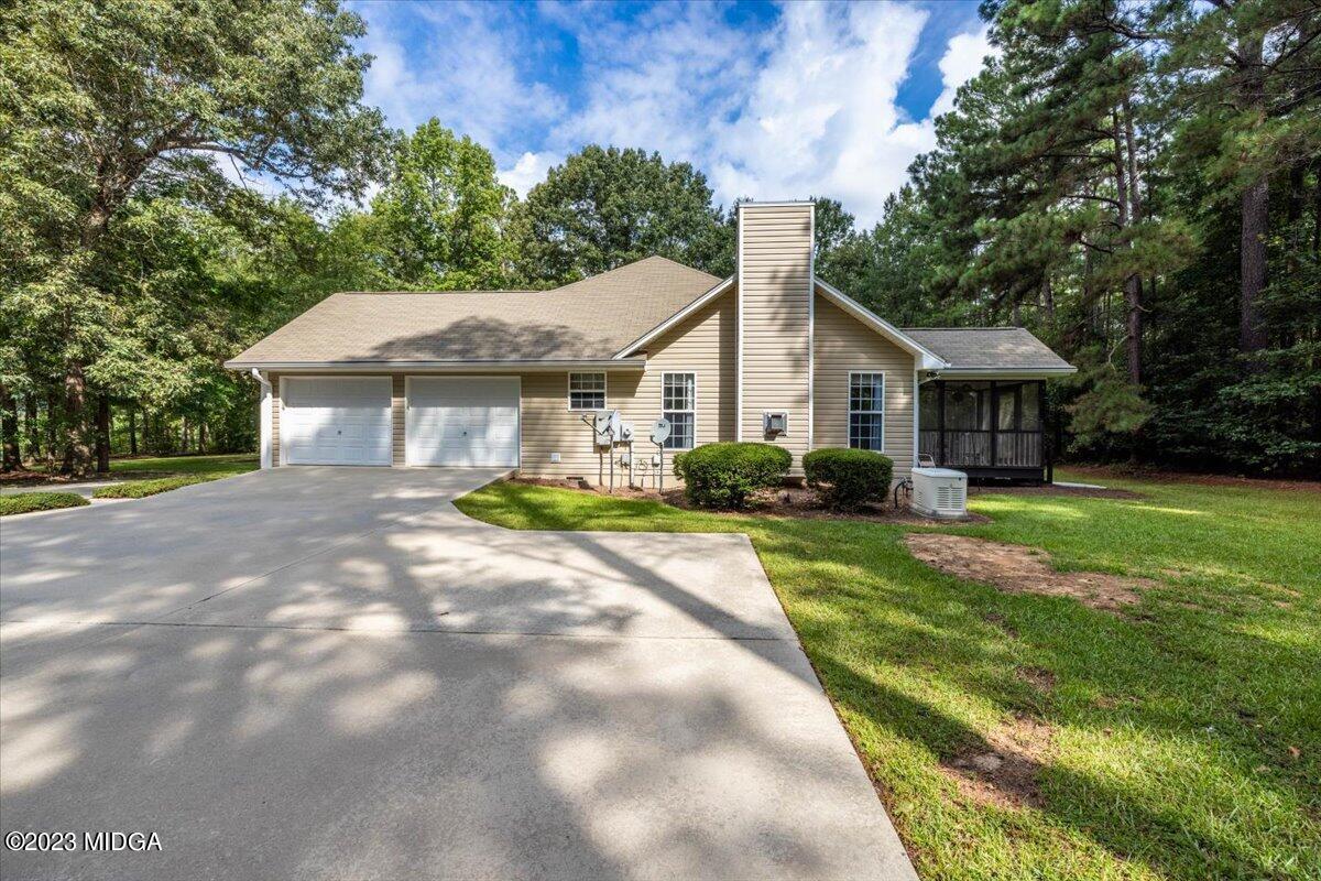 239 Altman Road Gray, GA 31032 - Photo 29 of 46 a house with green field in front of it