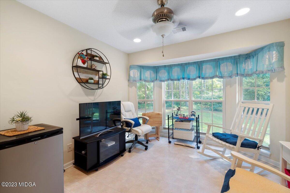 239 Altman Road Gray, GA 31032 - Photo 38 of 46 a living room with furniture and a fireplace