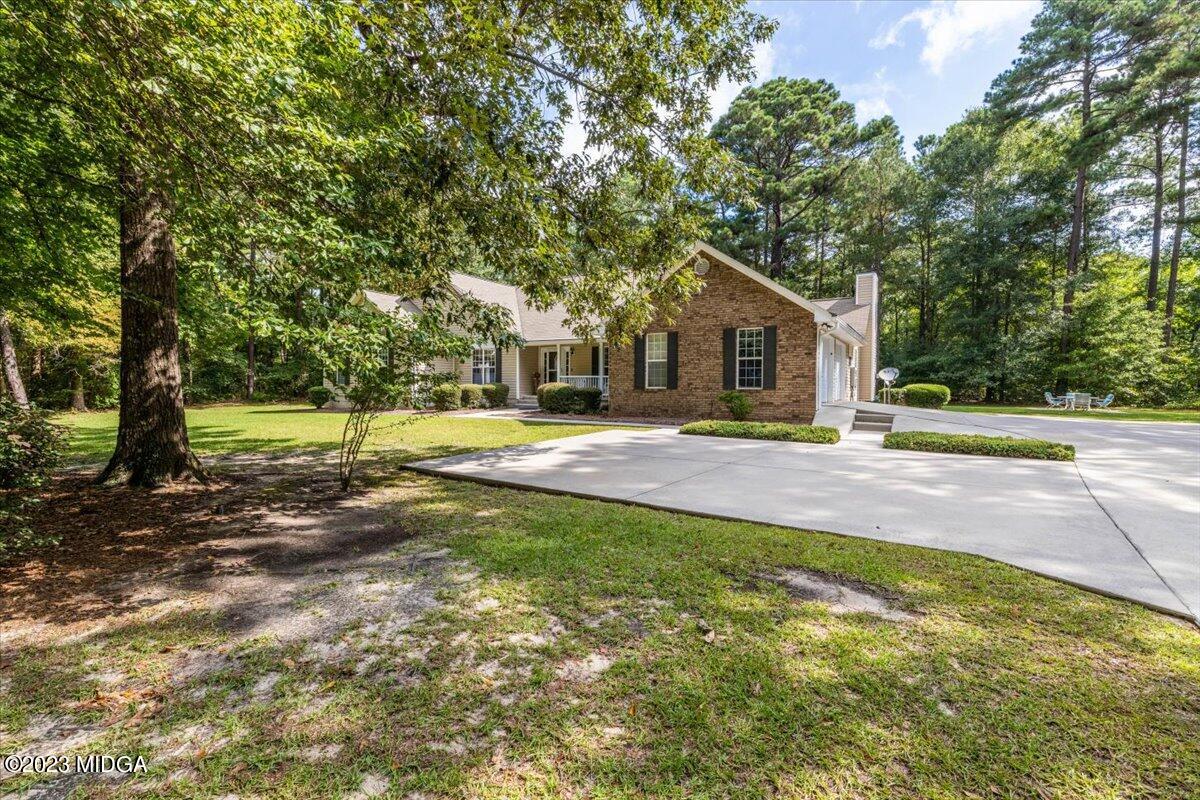 239 Altman Road Gray, GA 31032 - Photo 40 of 46 a view of a house with a big yard and large trees