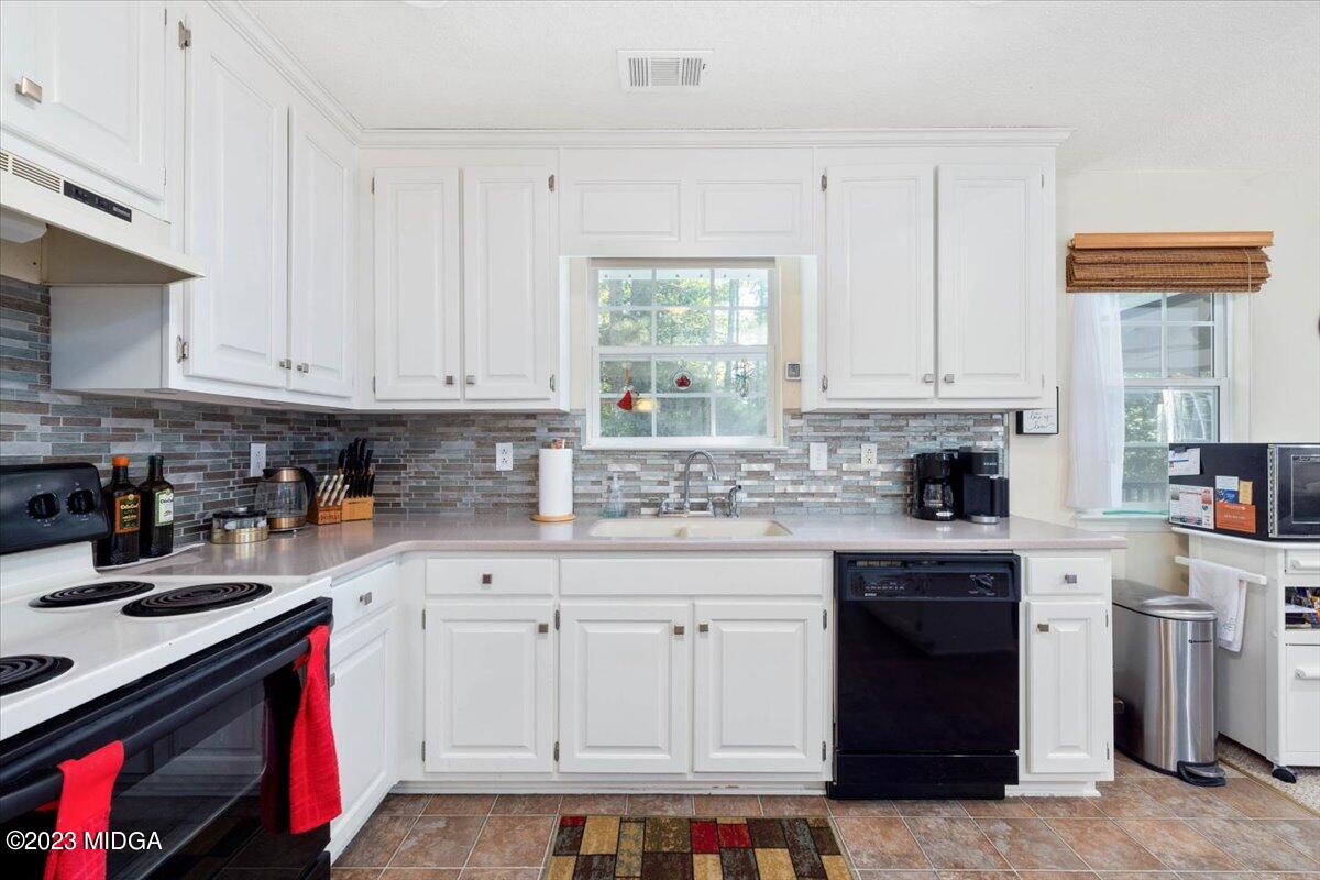 239 Altman Road Gray, GA 31032 - Photo 8 of 46 a kitchen with stainless steel appliances granite countertop a stove sink and cabinets