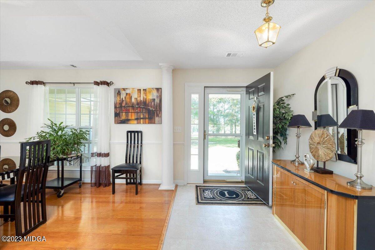 239 Altman Road Gray, GA 31032 - Photo 9 of 46 a view of living room kitchen with furniture and floor to ceiling window